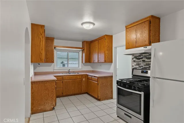 a kitchen with a stove top oven a sink and dishwasher
