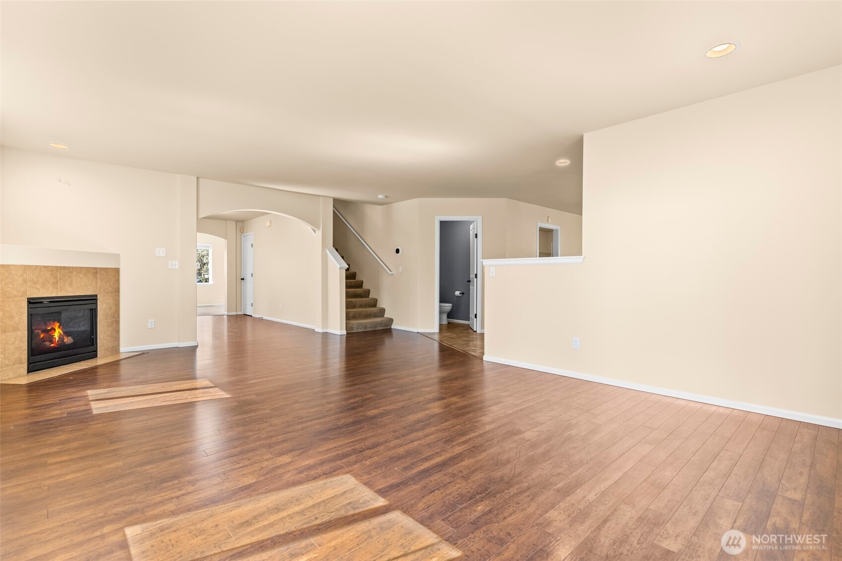 1408 Daffodil Avenue Northeast Orting, WA 98360 - Photo 11 of 37 a view of a livingroom with wooden floor and a fireplace