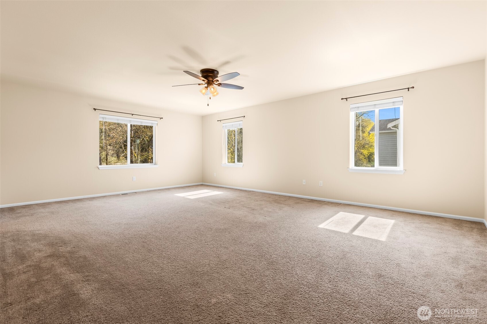 1408 Daffodil Avenue Northeast Orting, WA 98360 - Photo 17 of 37 a view of a big room with windows and chandelier fan