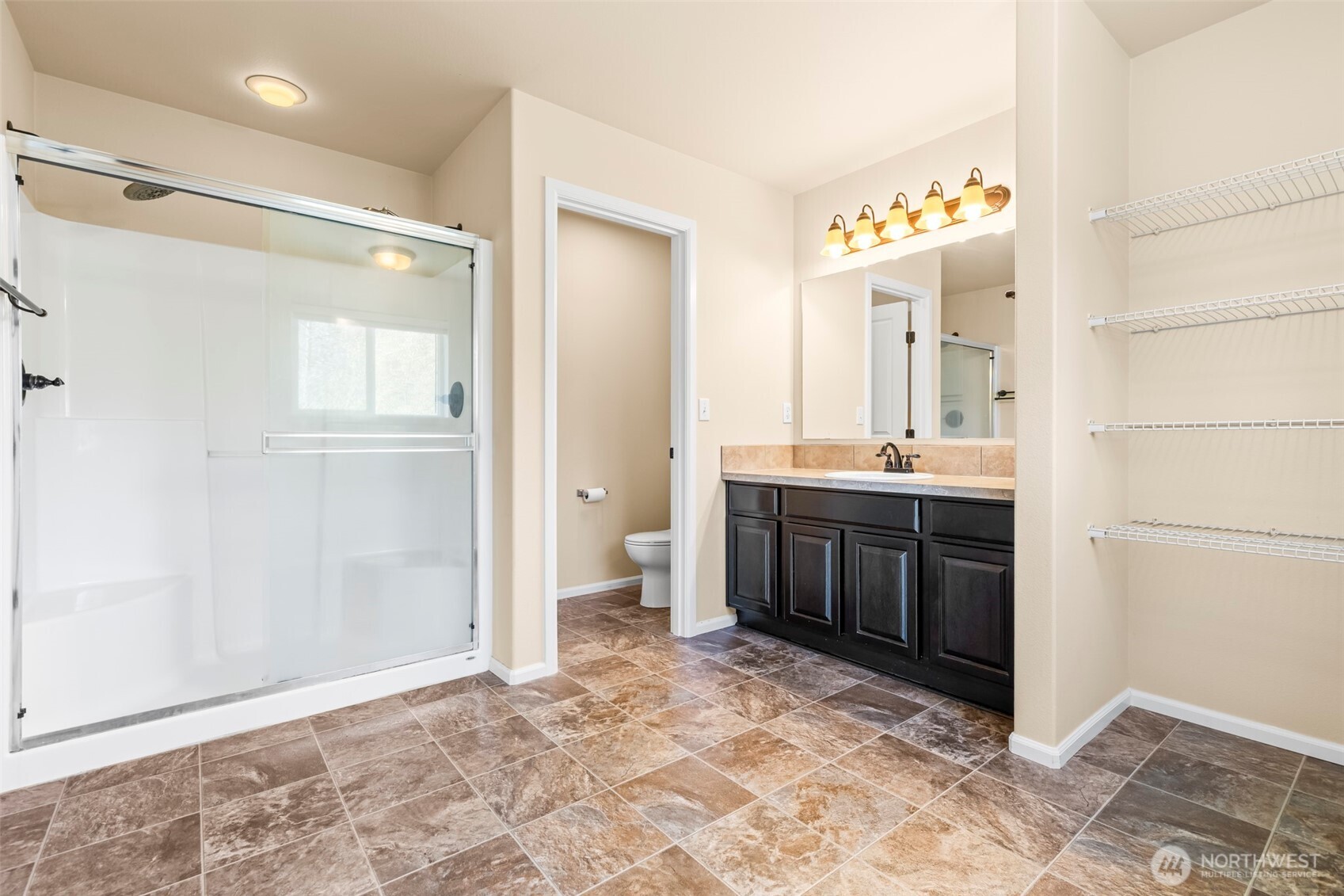 1408 Daffodil Avenue Northeast Orting, WA 98360 - Photo 20 of 37 a spacious bathroom with a mirror sink and vanity