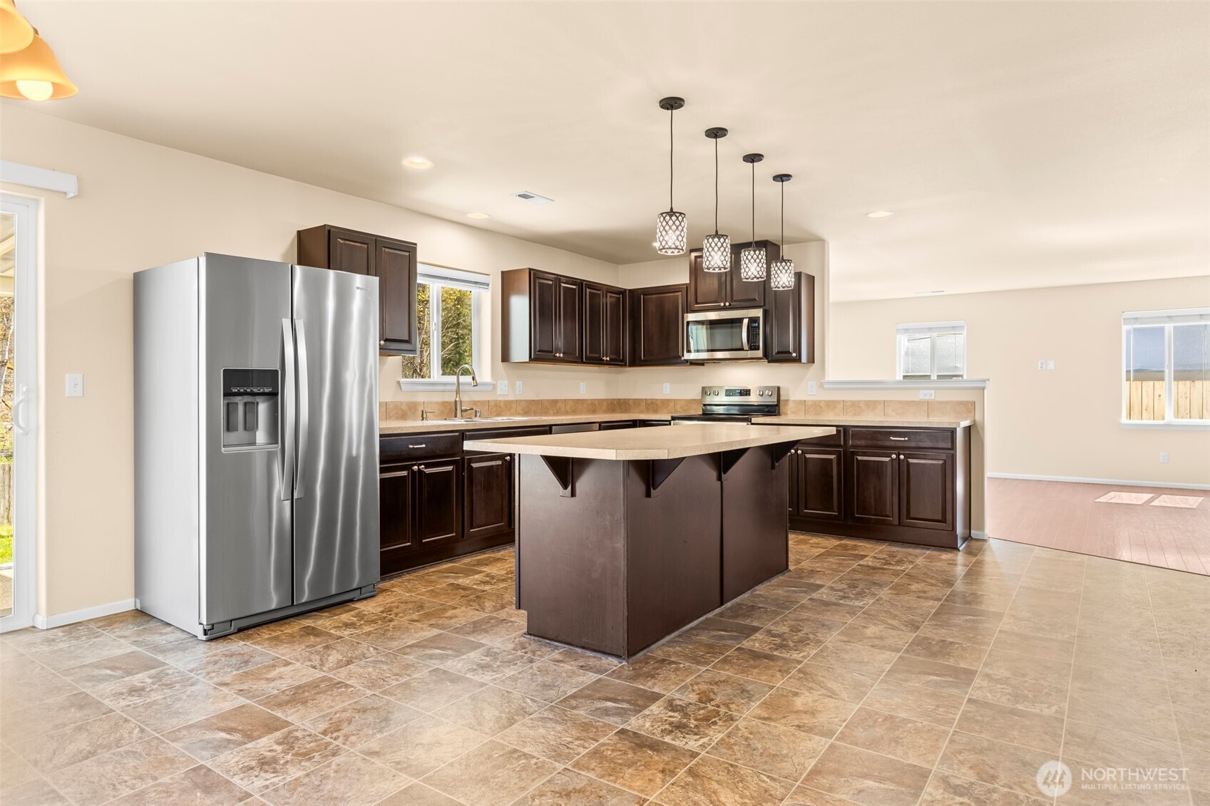 1408 Daffodil Avenue Northeast Orting, WA 98360 - Photo 2 of 37 a kitchen with stainless steel appliances granite countertop a stove a sink dishwasher a refrigerator and a oven