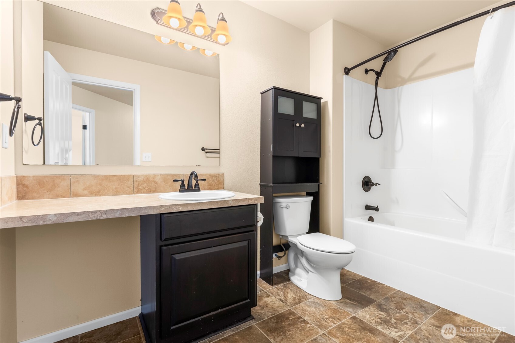1408 Daffodil Avenue Northeast Orting, WA 98360 - Photo 26 of 37 a bathroom with a sink toilet mirror and shower