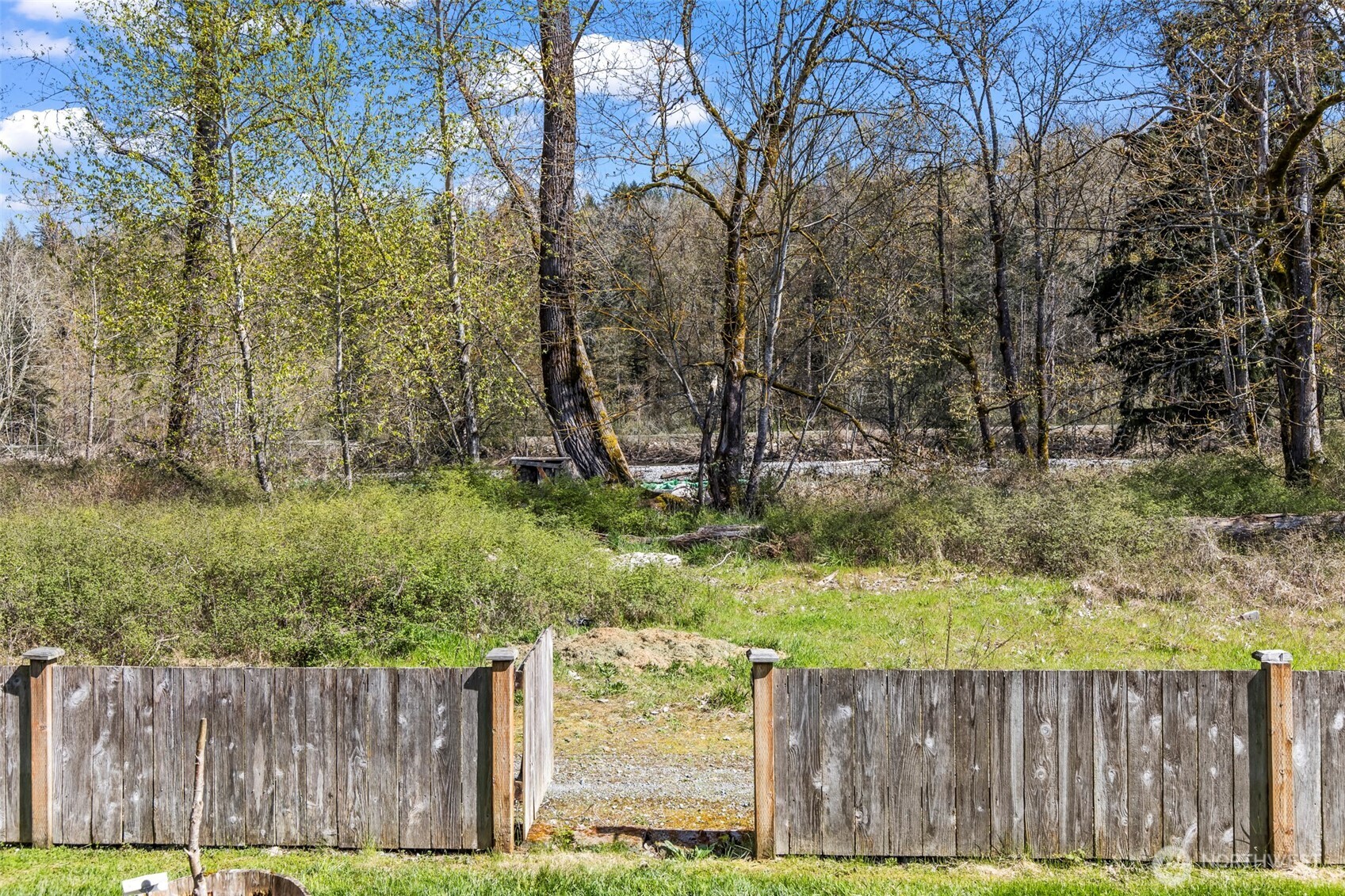 1408 Daffodil Avenue Northeast Orting, WA 98360 - Photo 30 of 37 a view of a backyard with wooden fence