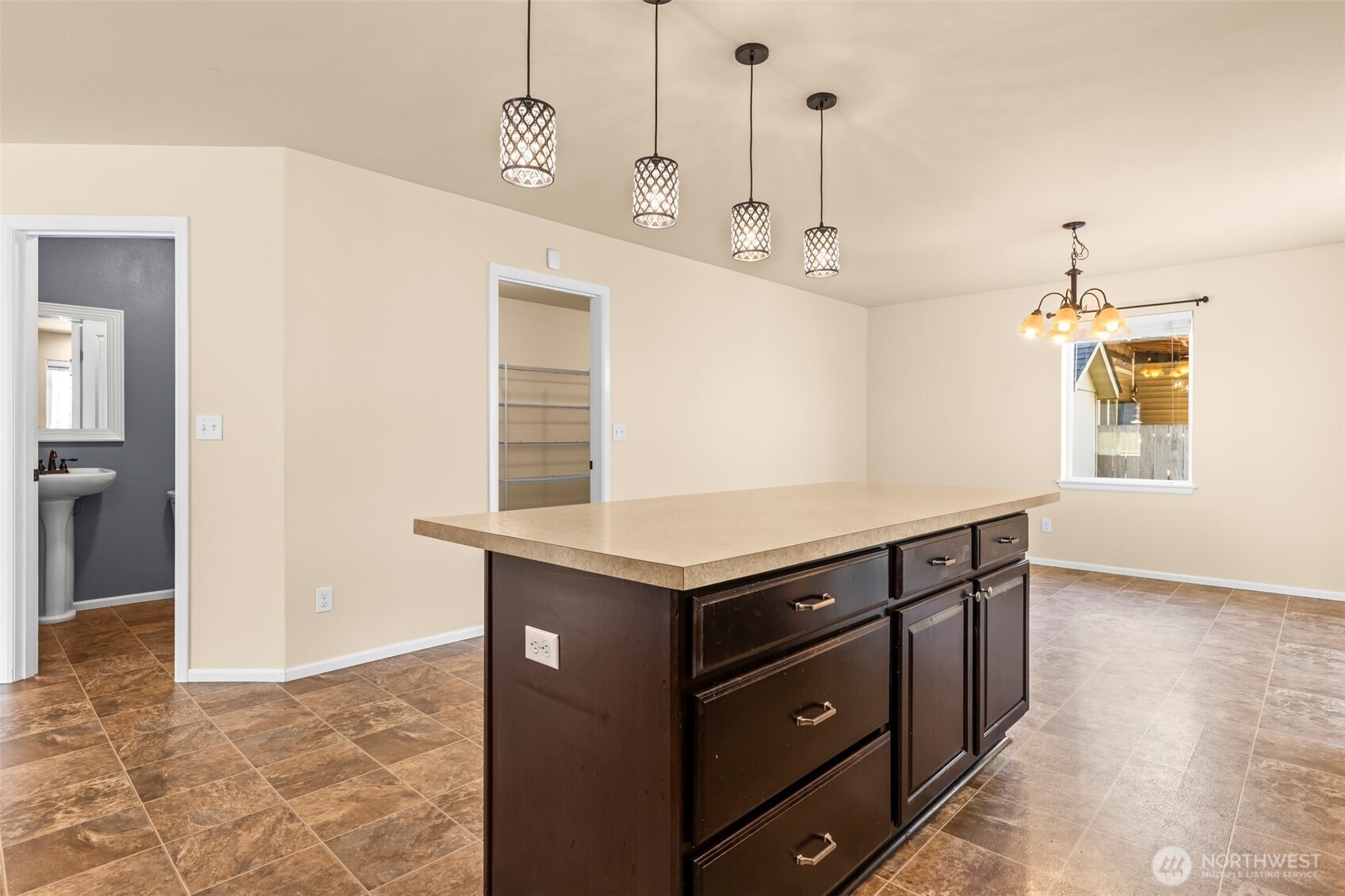 1408 Daffodil Avenue Northeast Orting, WA 98360 - Photo 5 of 37 a kitchen with kitchen island cabinets and wooden floor