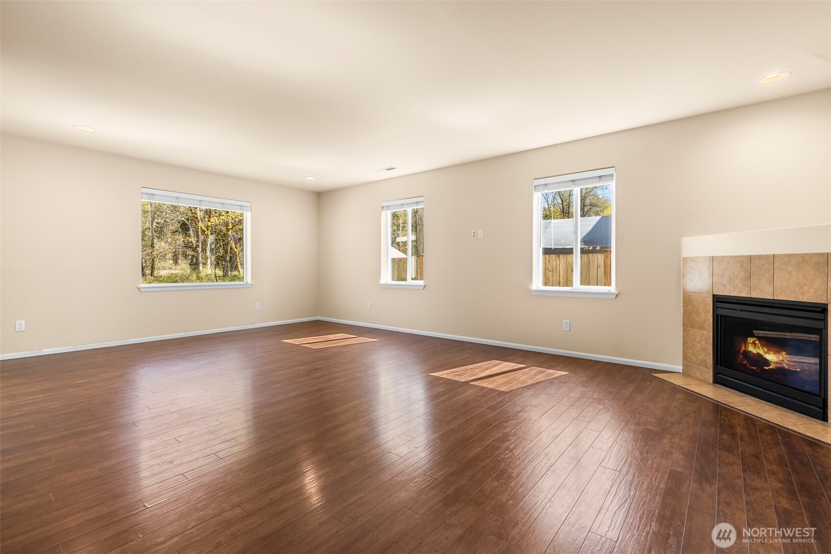 1408 Daffodil Avenue Northeast Orting, WA 98360 - Photo 9 of 37 a view of an empty room with wooden floor and a window