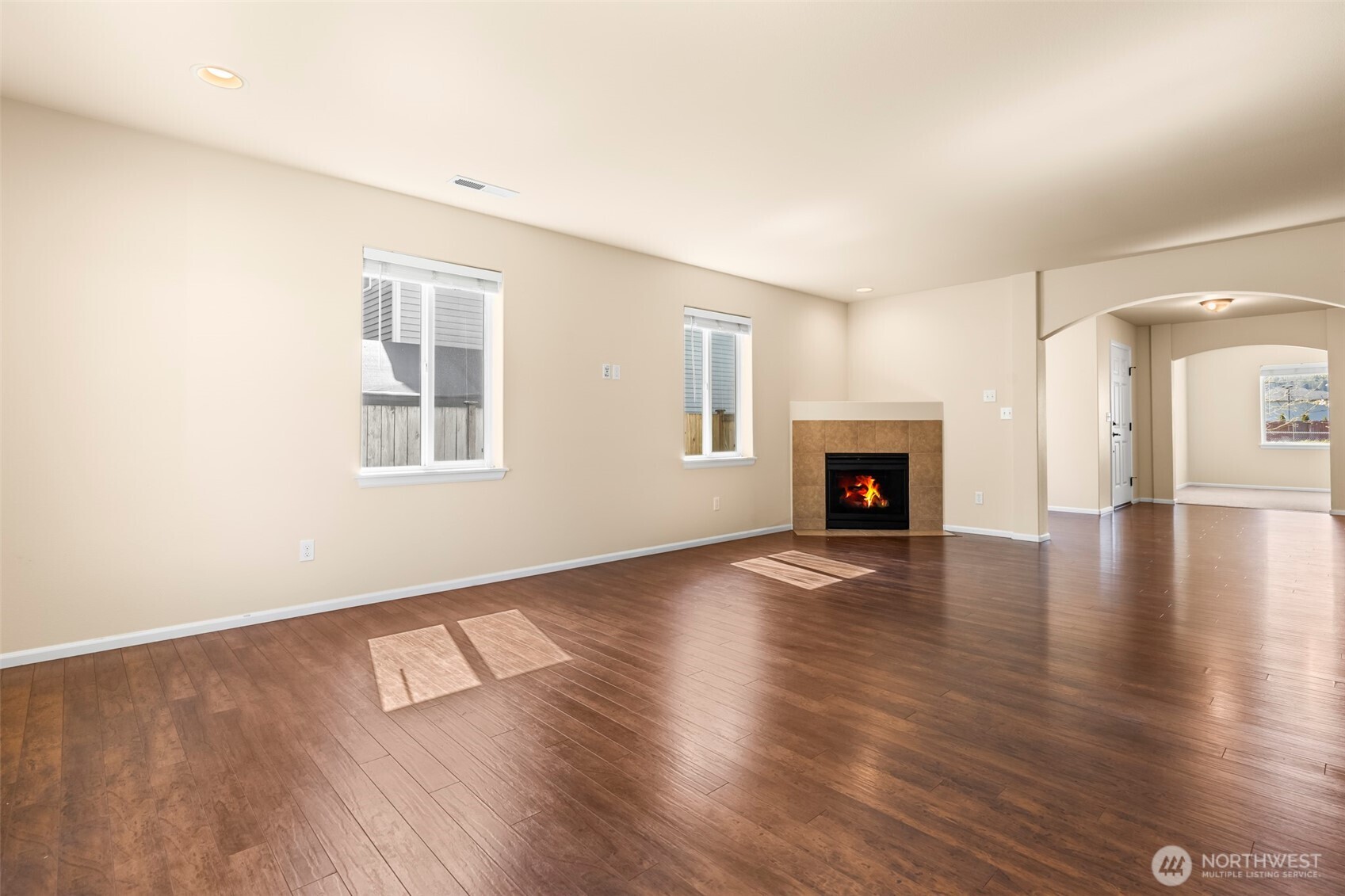 1408 Daffodil Avenue Northeast Orting, WA 98360 - Photo 10 of 37 a view of a livingroom with wooden floor and a fireplace