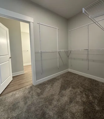 a spacious bathroom with a toilet a sink and mirror