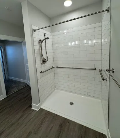 a living room with furniture wooden floor and large windows