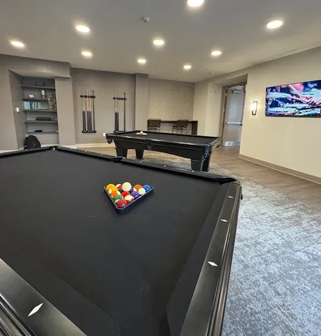 a view of an empty room with a fireplace and a window