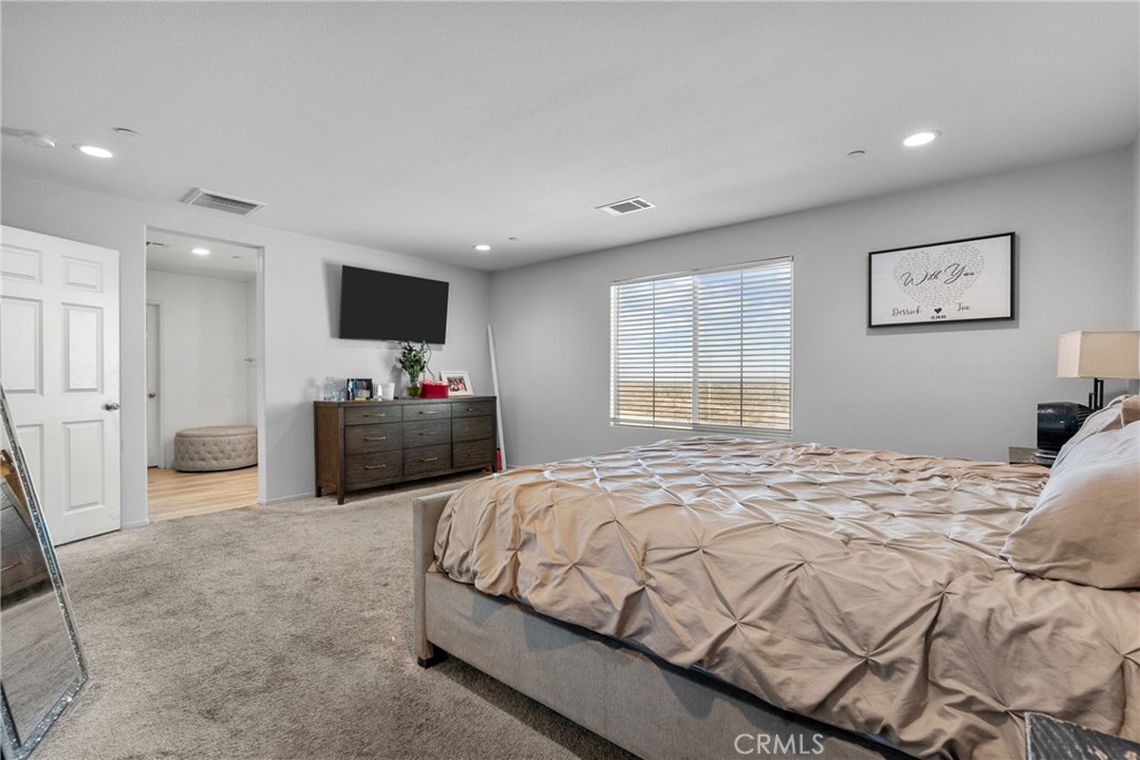 6949 Beale Road Palmdale, CA 93552 - Photo 22 of 32 a bedroom with a bed a television and a large window
