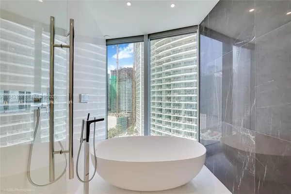 a bathroom with a bathtub and a shower