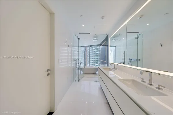 a bathroom with a double vanity sink toilet and shower