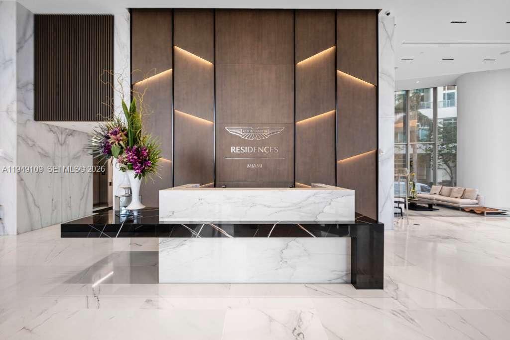 300 Biscayne Blvd Way, Unit 2307W Miami, FL 33131 - Photo 17 of 22 a bathroom with a granite countertop sink a mirror and shower