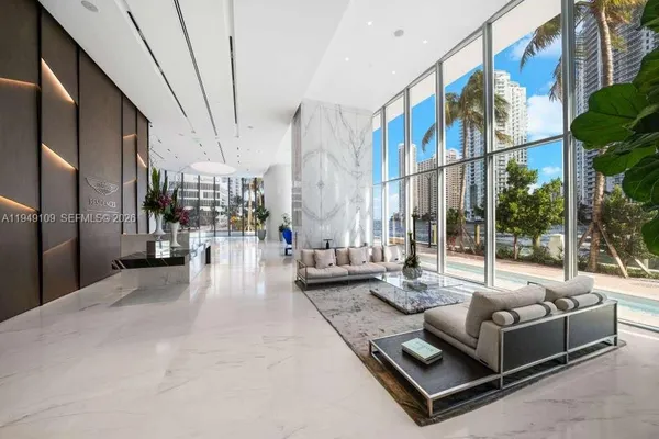 a living room with couches a large window with outer view