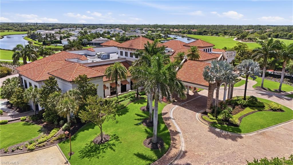 9479 Piacere Way Naples, FL 34113 - Photo 48 of 48 Mediterranean-style Golf Clubhouse architecture with a tile roof, lush landscaping, and a paver drive