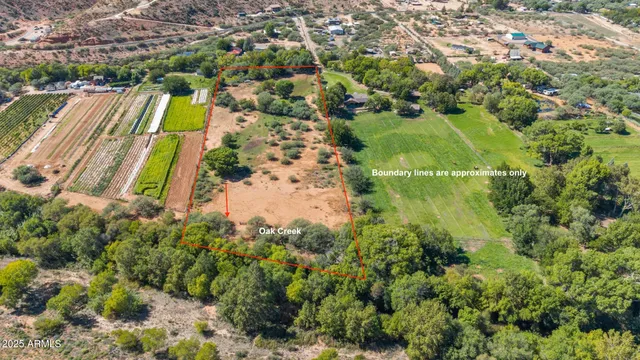 an aerial view of residential houses with outdoor space and trees