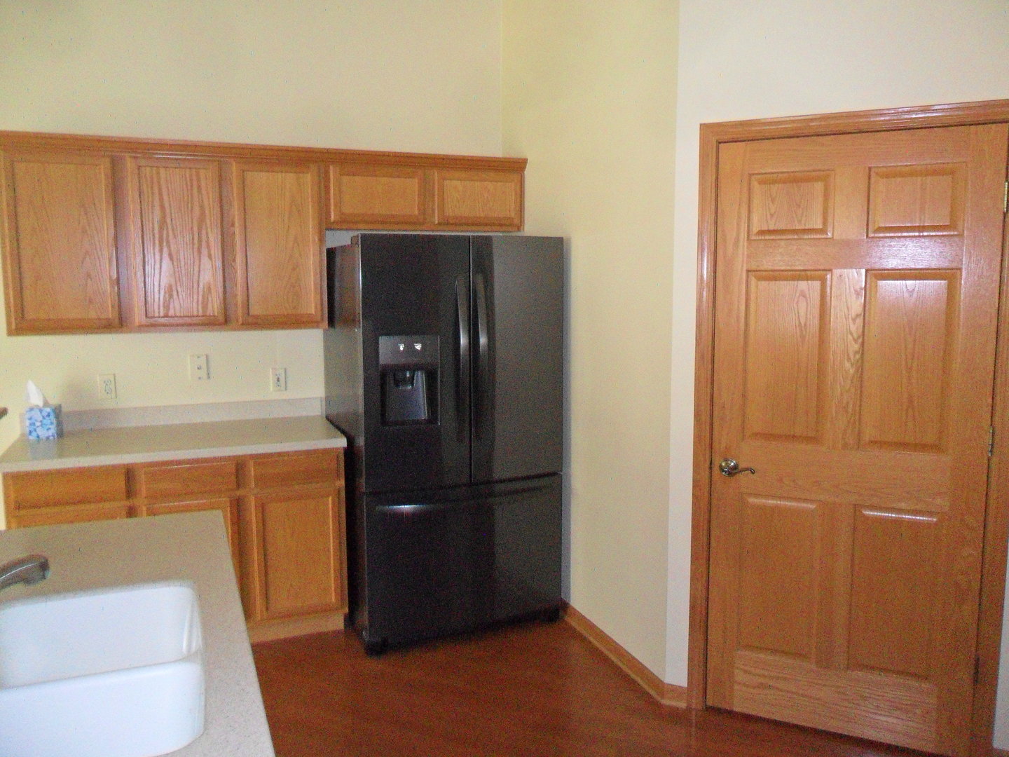 678 Cadillac Circle Romeoville, IL 60446 - Photo 8 of 19 a kitchen with a refrigerator and cabinets