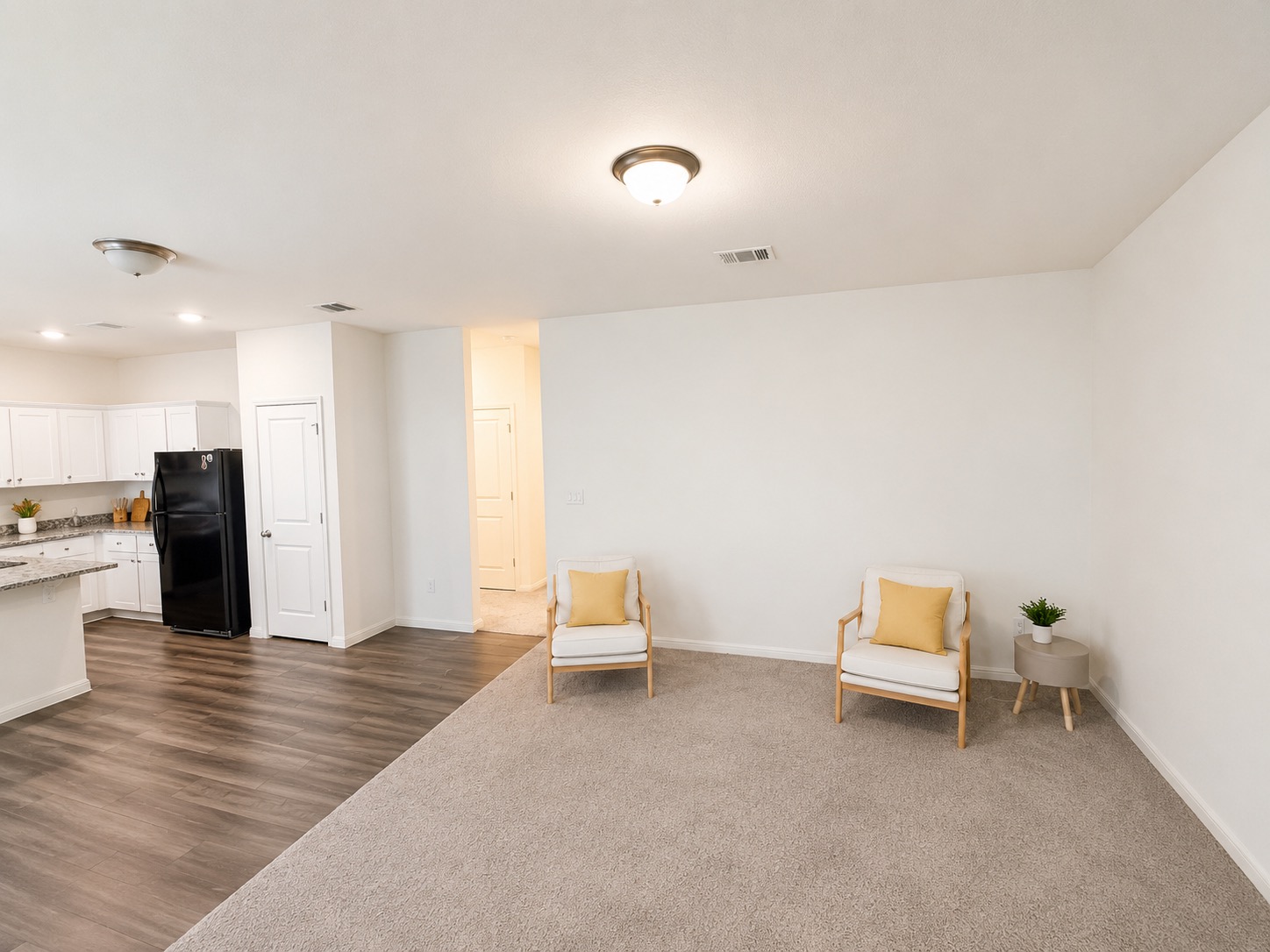 160 Light Timber Road Maxwell, TX 78656 - Photo 3 of 11 An open concept living area transitions seamlessly from kitchen to a carpeted lounge space.