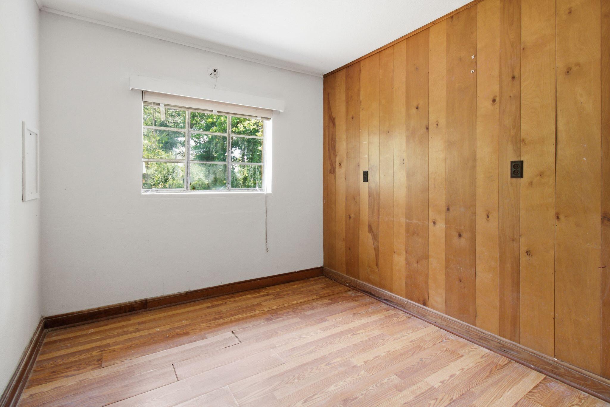 855 North Pearl Street Crestview, FL 32536 - Photo 26 of 31 a view of an empty room with wooden floor and a window