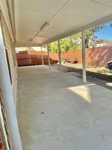an empty room with windows and fireplace