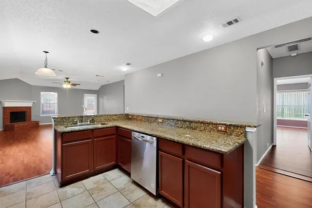 a kitchen with a sink and a stove top oven