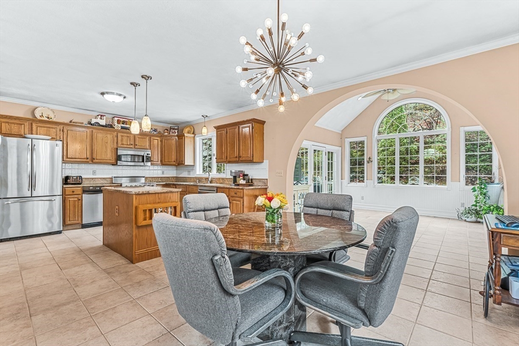71 Hammersmith Drive Saugus, MA 01906 - Photo 11 of 41 a dining room with furniture a kitchen and a chandelier
