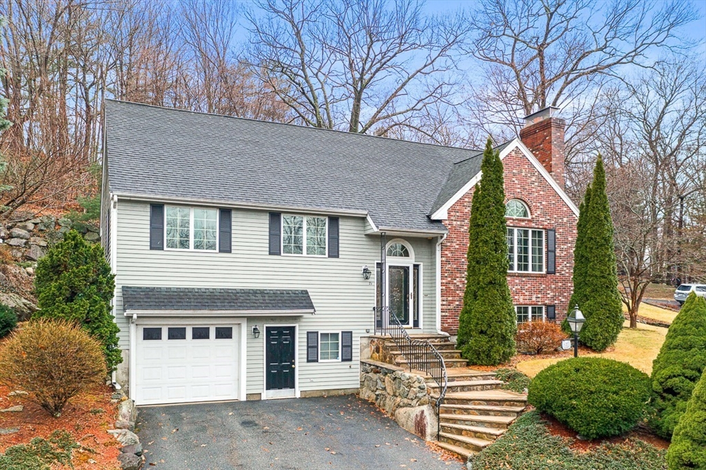 71 Hammersmith Drive Saugus, MA 01906 - Photo 2 of 41 a front view of a house with a yard and garage