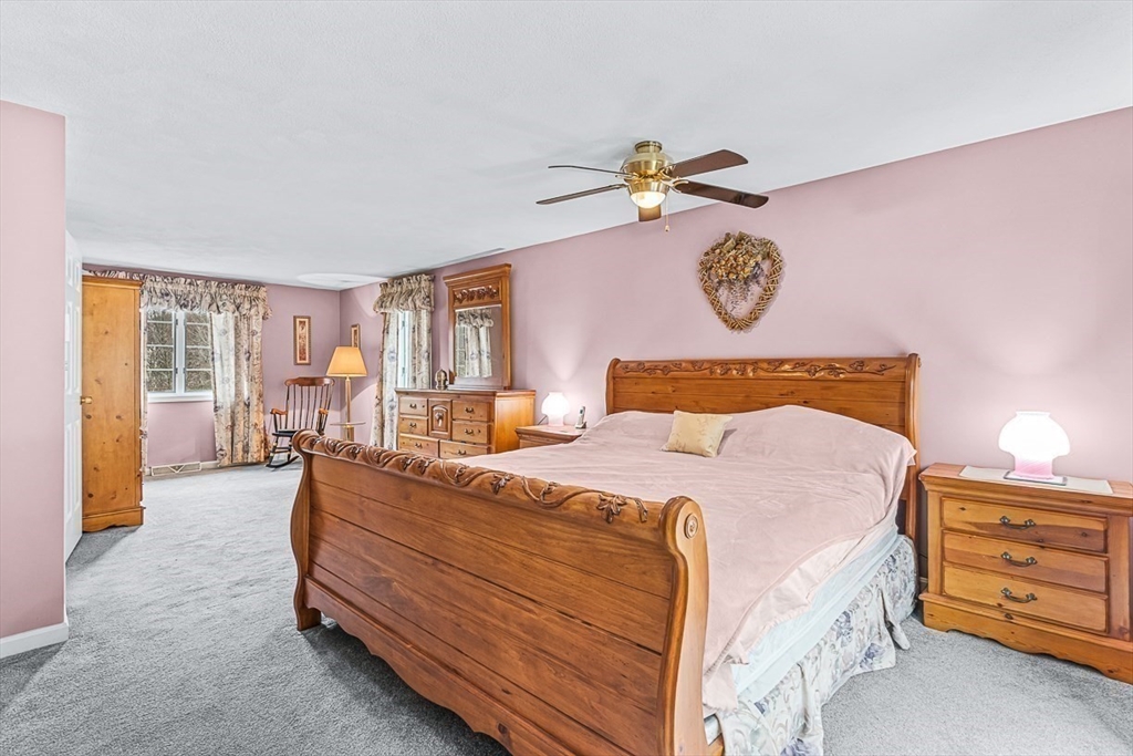 71 Hammersmith Drive Saugus, MA 01906 - Photo 21 of 41 a bedroom with a bed and wooden floor