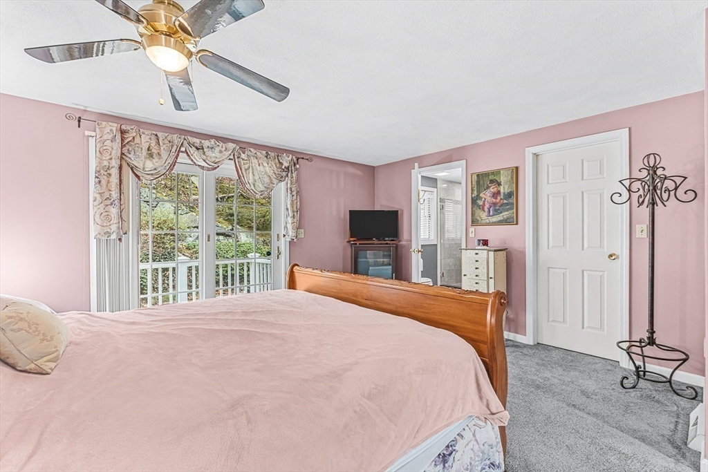 71 Hammersmith Drive Saugus, MA 01906 - Photo 22 of 41 a bedroom with a large bed and a chandelier