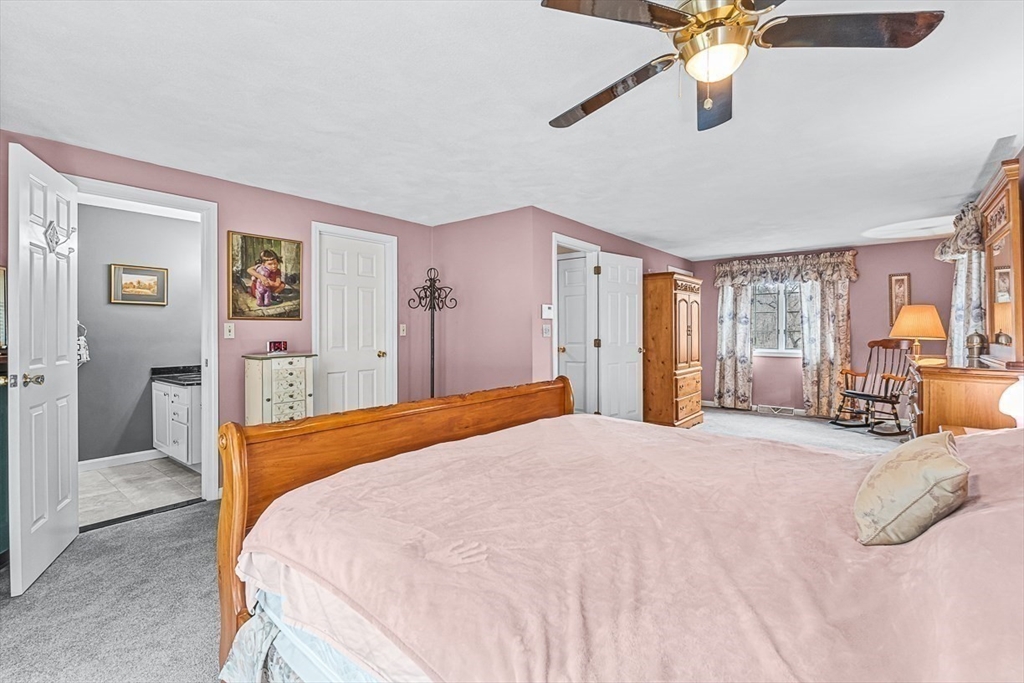 71 Hammersmith Drive Saugus, MA 01906 - Photo 23 of 41 a bedroom with a large bed and a chandelier