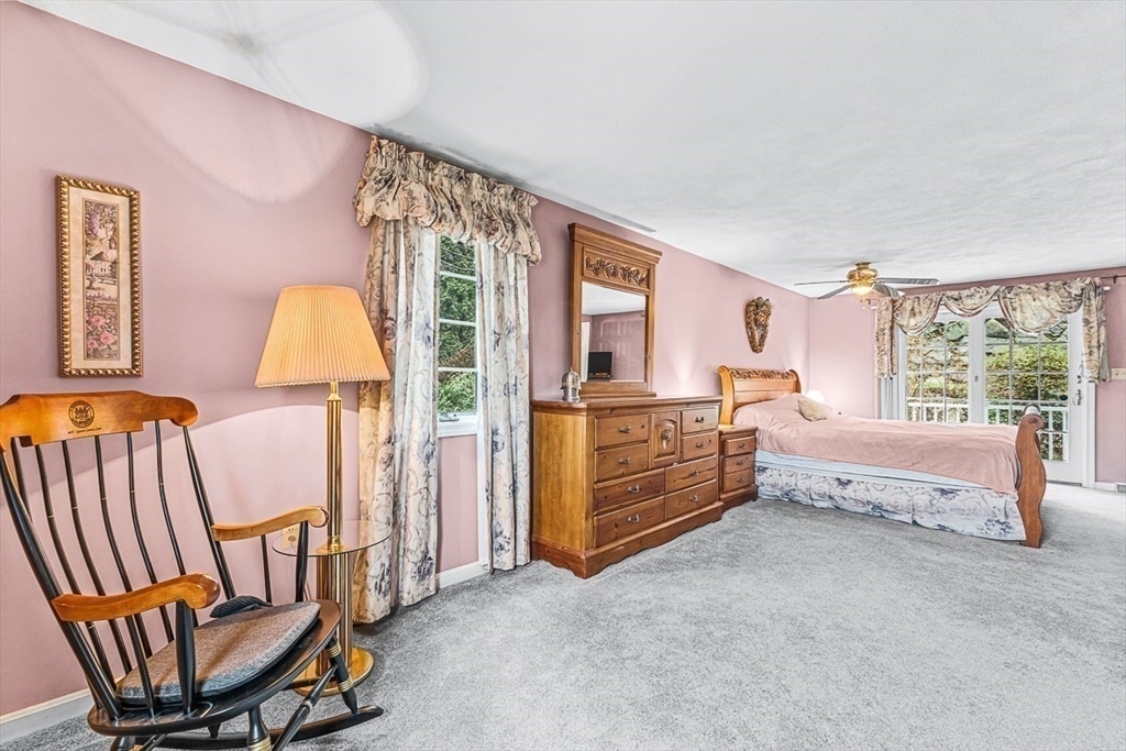 71 Hammersmith Drive Saugus, MA 01906 - Photo 25 of 41 a spacious bedroom with a bed and a chandelier