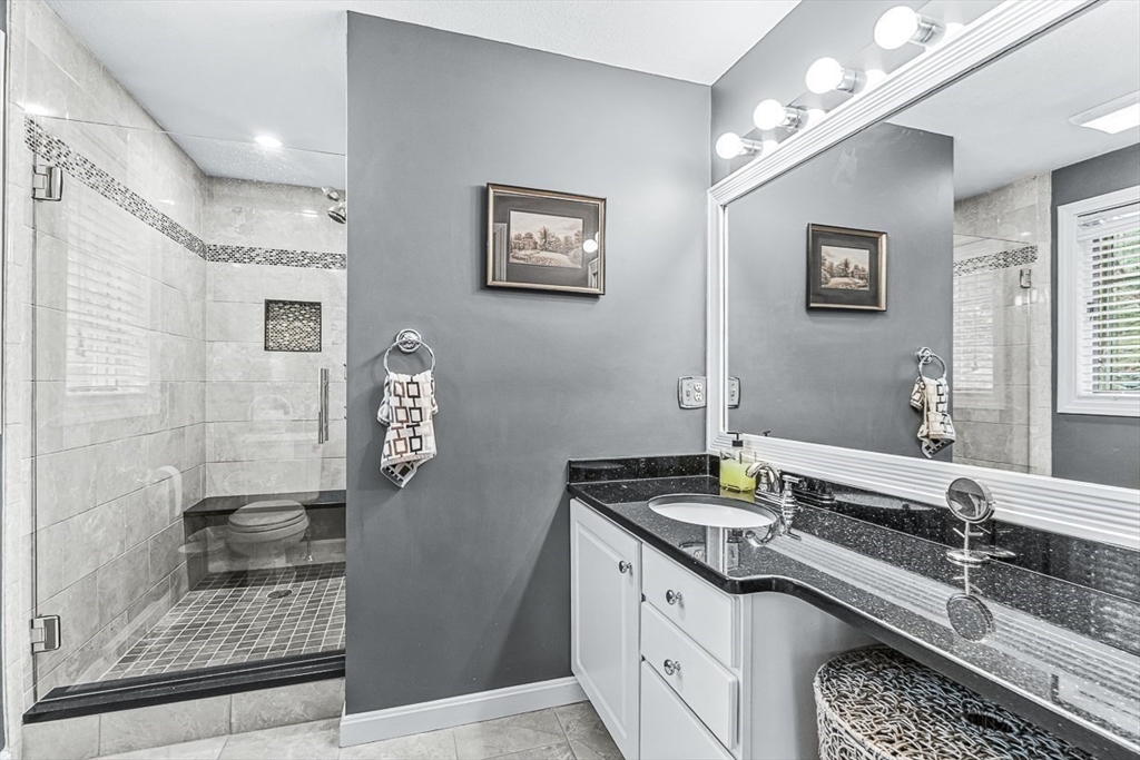 71 Hammersmith Drive Saugus, MA 01906 - Photo 26 of 41 a spacious bathroom with a granite countertop sink a mirror and shower