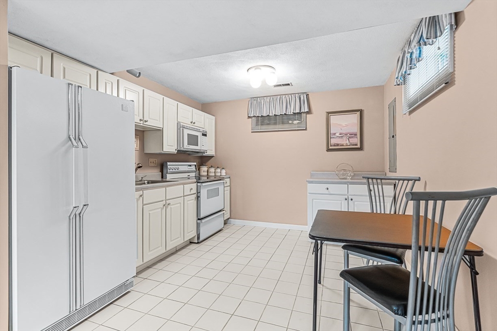 71 Hammersmith Drive Saugus, MA 01906 - Photo 32 of 41 a kitchen with stainless steel appliances a refrigerator and a stove top oven