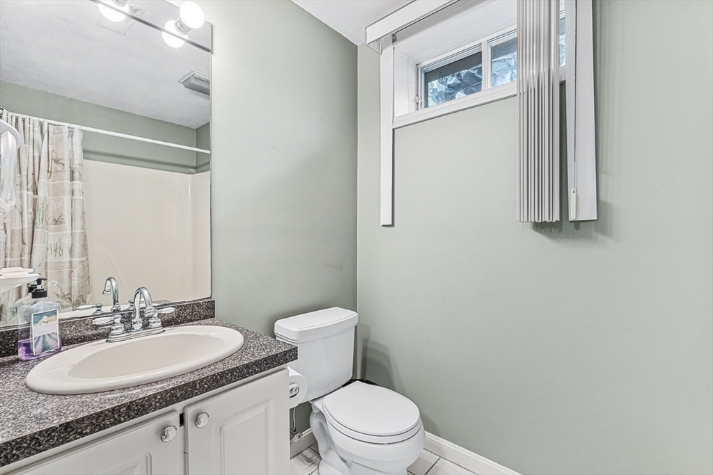 71 Hammersmith Drive Saugus, MA 01906 - Photo 38 of 41 a bathroom with a granite countertop sink toilet and mirror