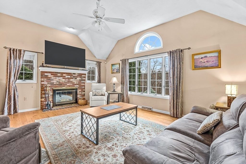 71 Hammersmith Drive Saugus, MA 01906 - Photo 5 of 41 a living room with furniture a flat screen tv and a fireplace