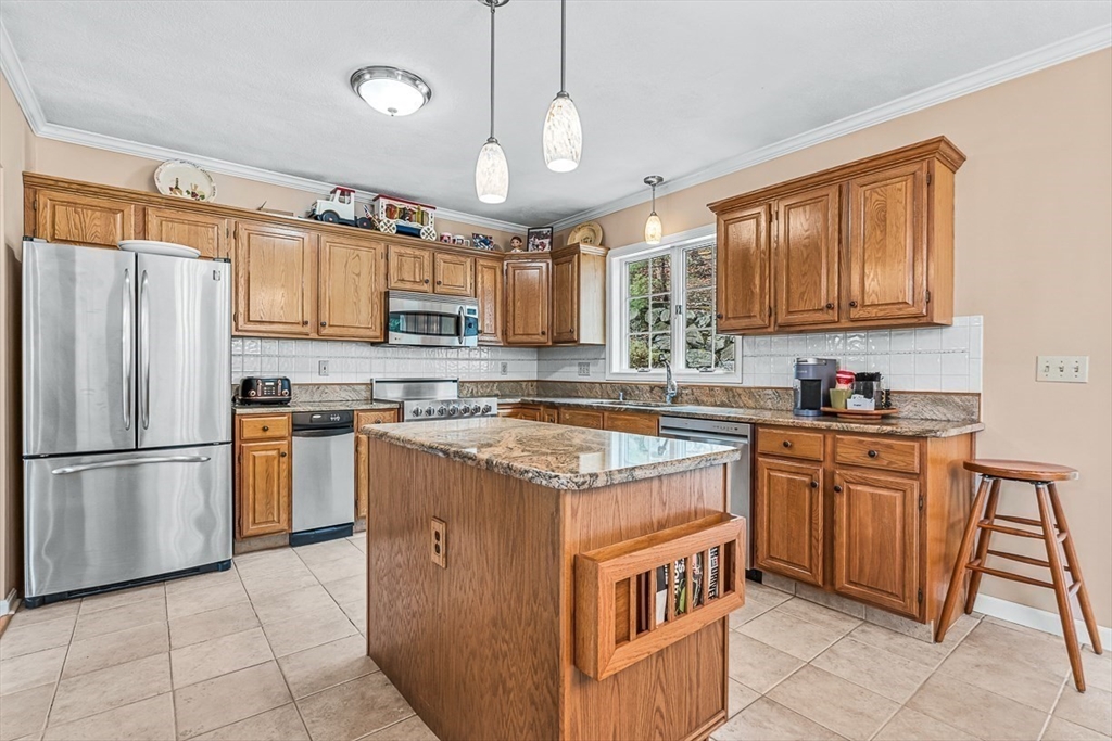 71 Hammersmith Drive Saugus, MA 01906 - Photo 9 of 41 a kitchen with stainless steel appliances granite countertop a stove a sink dishwasher a refrigerator and a microwave