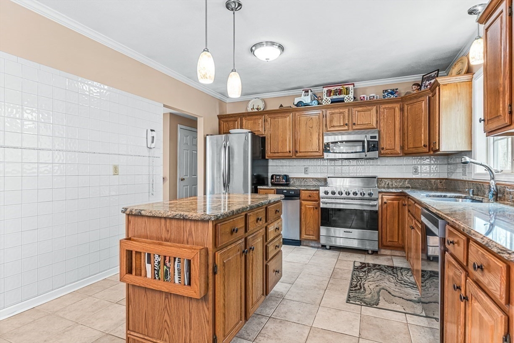 71 Hammersmith Drive Saugus, MA 01906 - Photo 10 of 41 a kitchen with stainless steel appliances granite countertop a stove a sink and a refrigerator