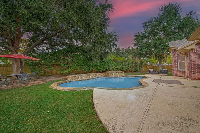 a view of a swimming pool with a patio
