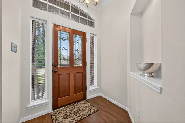 a view of an entryway with wooden floor