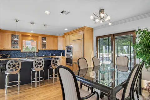 a dining room with furniture a chandelier and wooden floor
