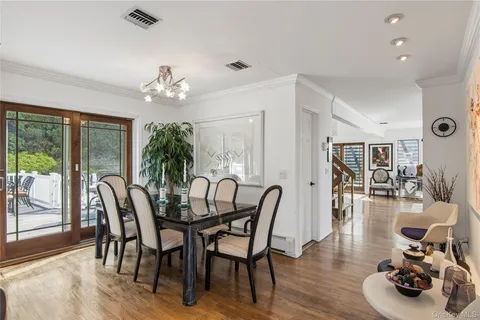 a dining room with furniture wooden floor and a chandelier