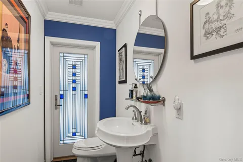a bathroom with a toilet a sink and mirror