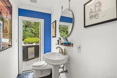 a bathroom with a toilet sink and mirror