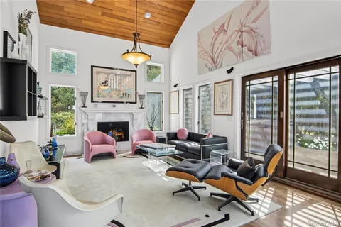 a living room with furniture a fireplace and windows
