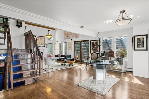 a living room with lots of furniture and a chandelier