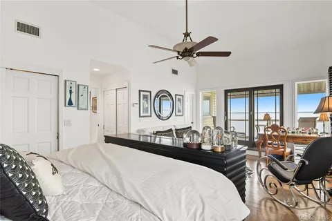 a bed room with a bed a dresser and chair