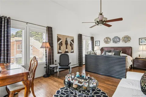 a view of a workspace with furniture and a window