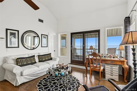 a living room with furniture a rug and a large window