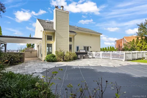 a view of a garden with plants and a bench