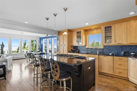 a kitchen that has a table chairs in it and wooden floors